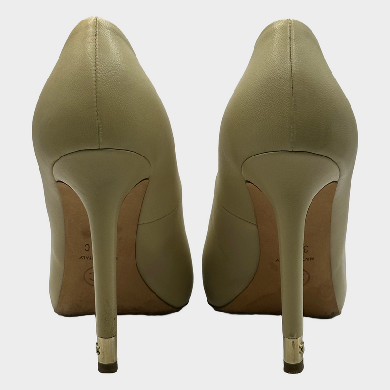 Chanel beige leather pumps with metal logo CC detail at the heels